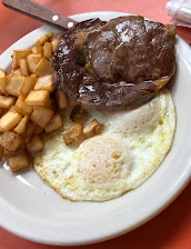 Ribeye steak with eggs and home fries