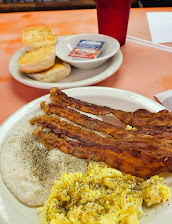 Two eggs, bacon, and creamy grits